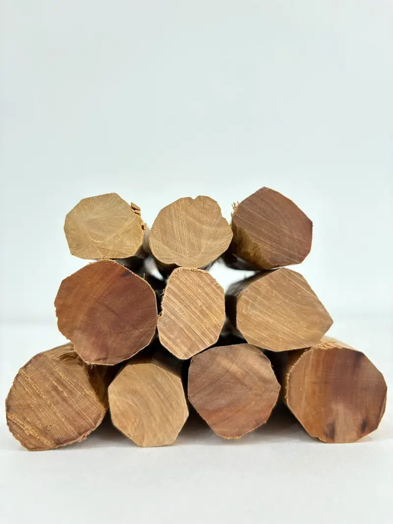 Stack of desapped Santalum album heartwood logs