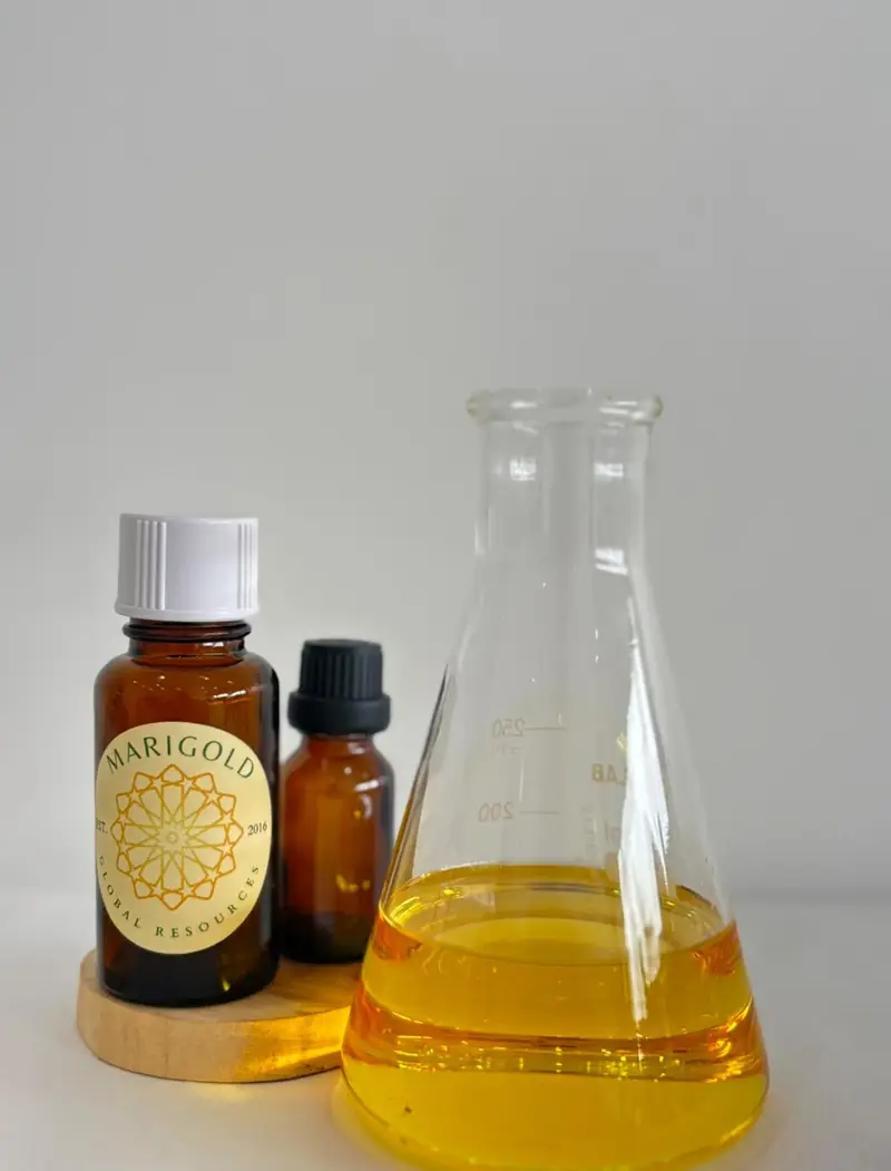 A bottle of sandalwood oil beside a flask